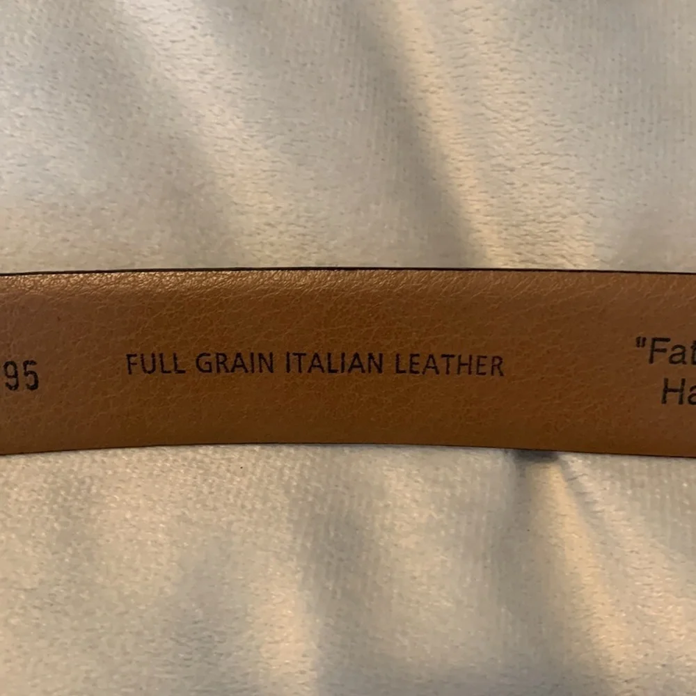 The mens warehouse smooth brown leather belt made in Italy size 38 thin dressy